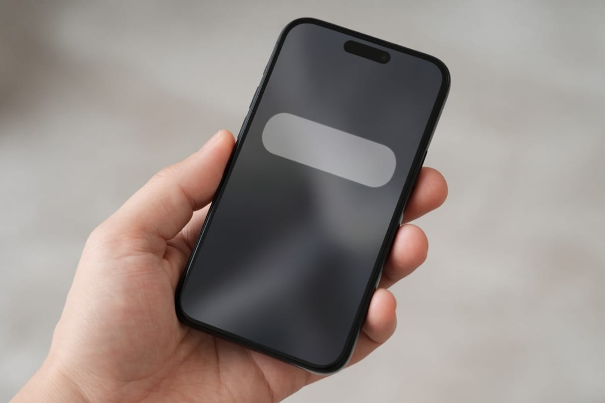 Hand holding a phone with a benefits notification on the lock screen